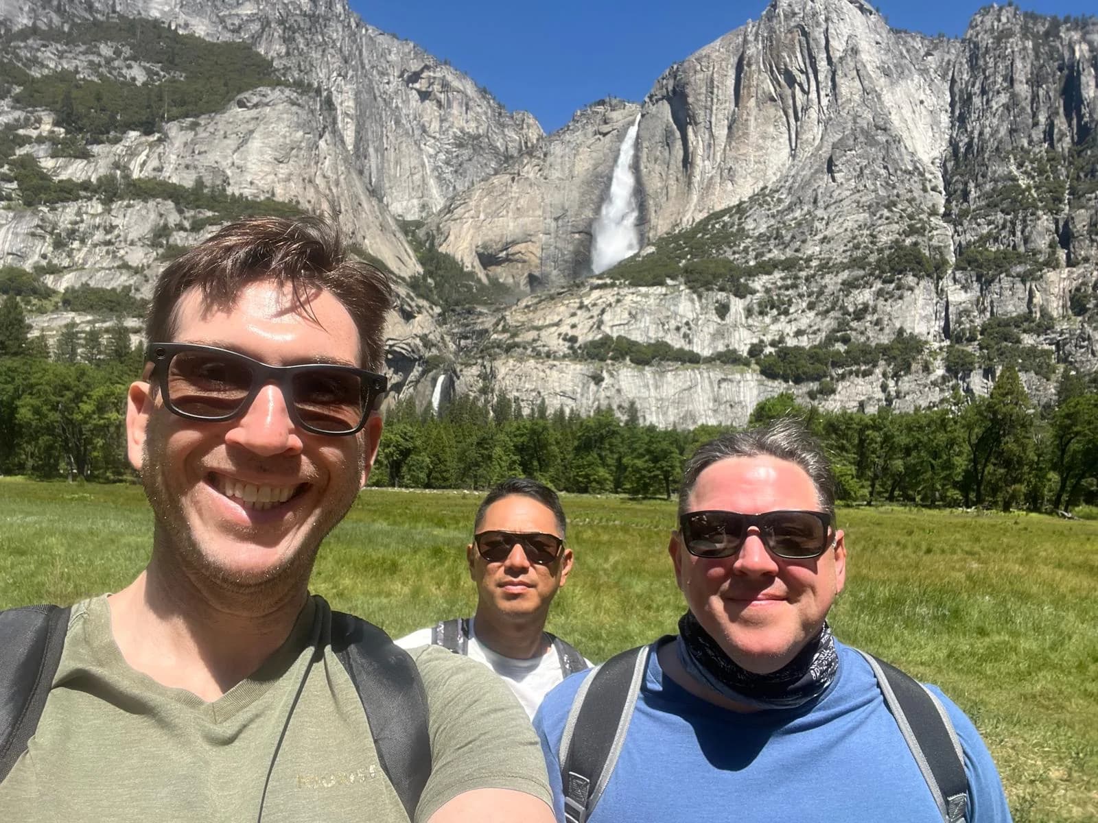 Yori, Matt Bivens, and James Gregson together in Yosemite Valley with Yosemite Falls and granite cliffs behind them