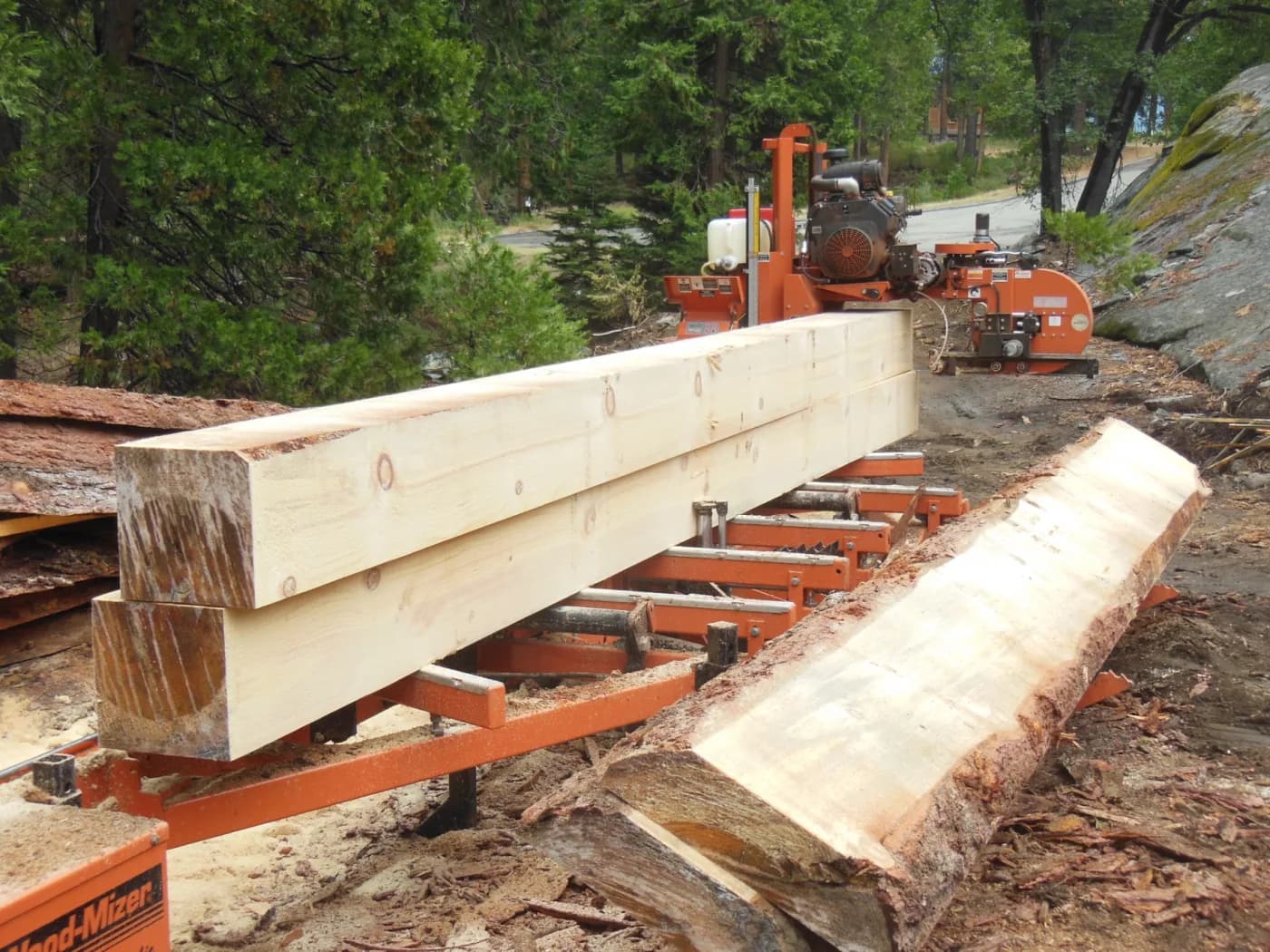 Large timber beams staged at Fresno Forest Creations