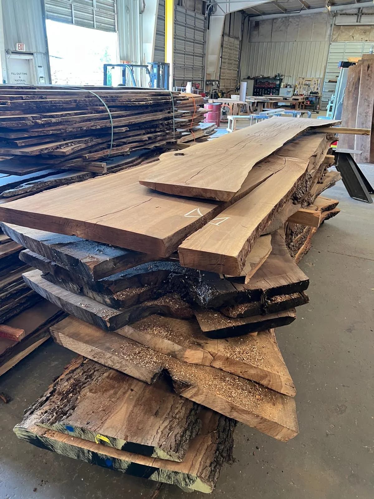 Stacks of Oklahoma Black Walnut slabs inside Urban Wood Company